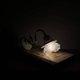 Swan neck wall light in brass with rose petal glass shade.