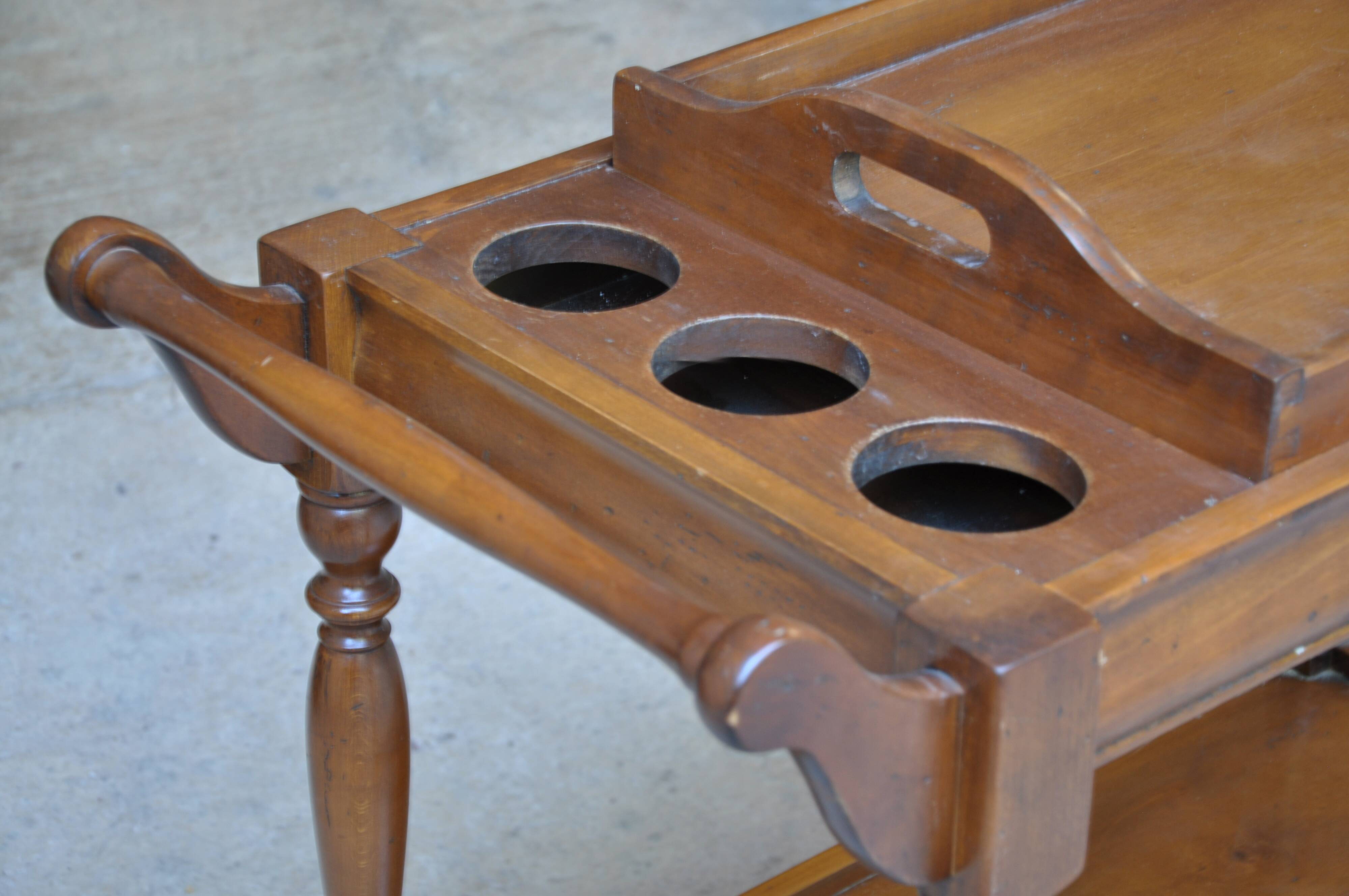 Serving table with a tray, on wheels, made of solid exotic wood.