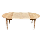 Round extendable dining table with flaps, stripped in raw walnut, with 2 extensions.