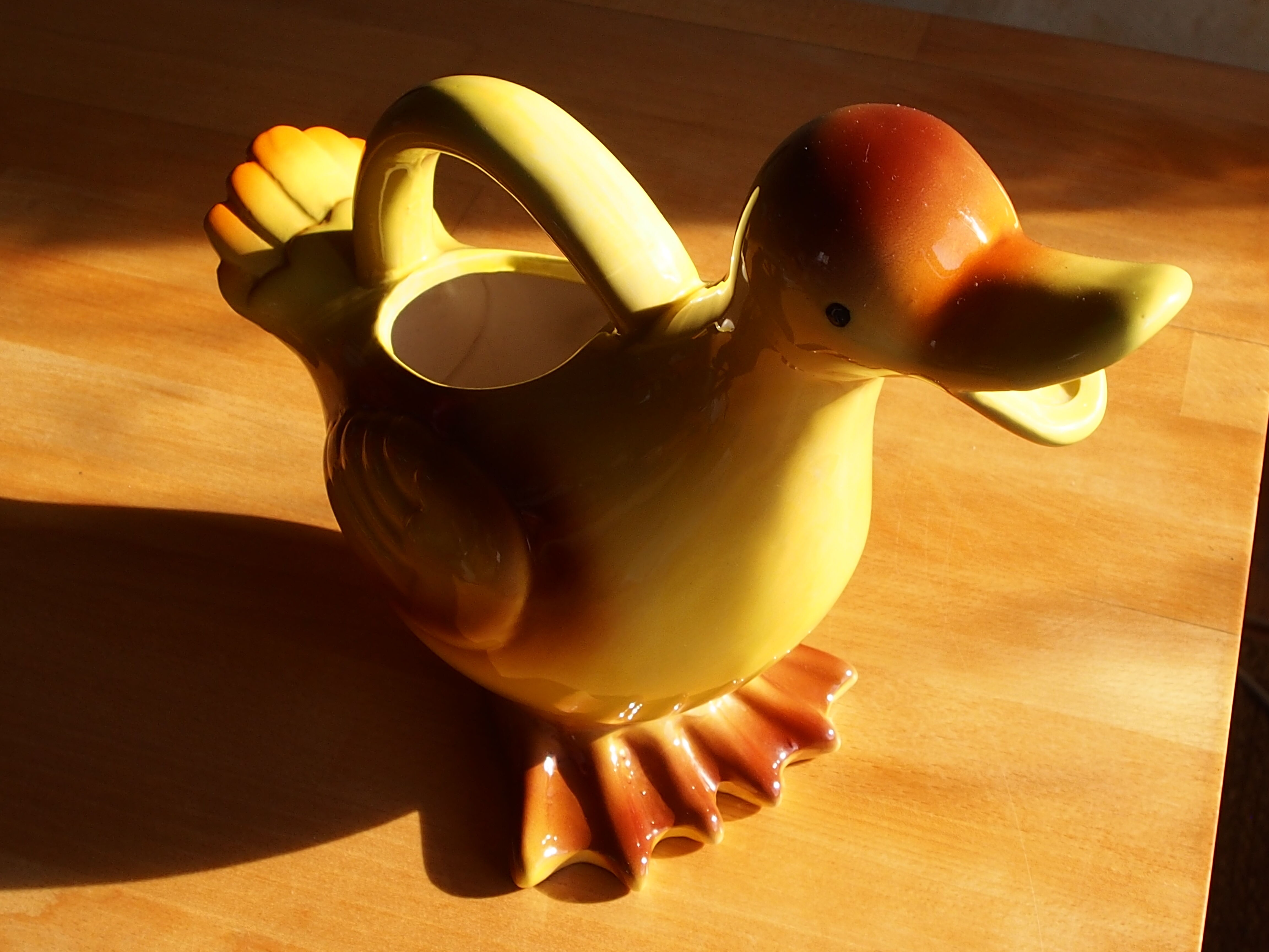Ceramic watering can in white earthenware, yellow enamel and bird shape