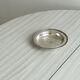 Round patinated silver-plated metal dish