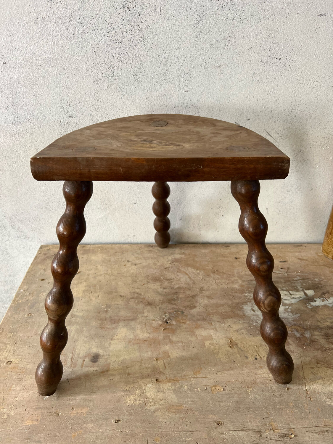 Wooden tripod farm stool