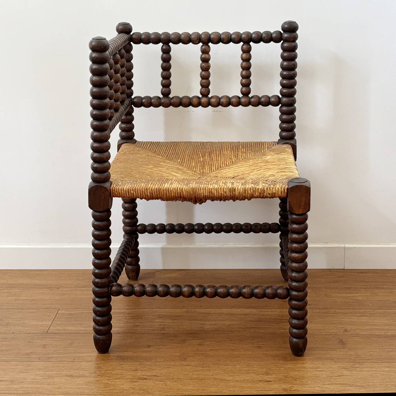 Turned wood corner chair with straw seat