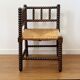 Turned wood corner chair with straw seat