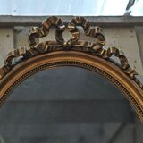 Louis XVI-style oval mirror in gilded stucco circa 1900