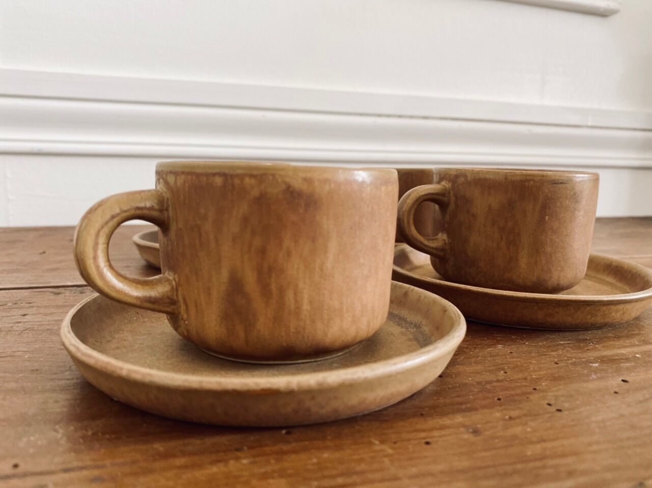 4 stoneware coffee cups and saucers