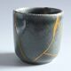 A pair of artisanal cups in traditional kintsugi.