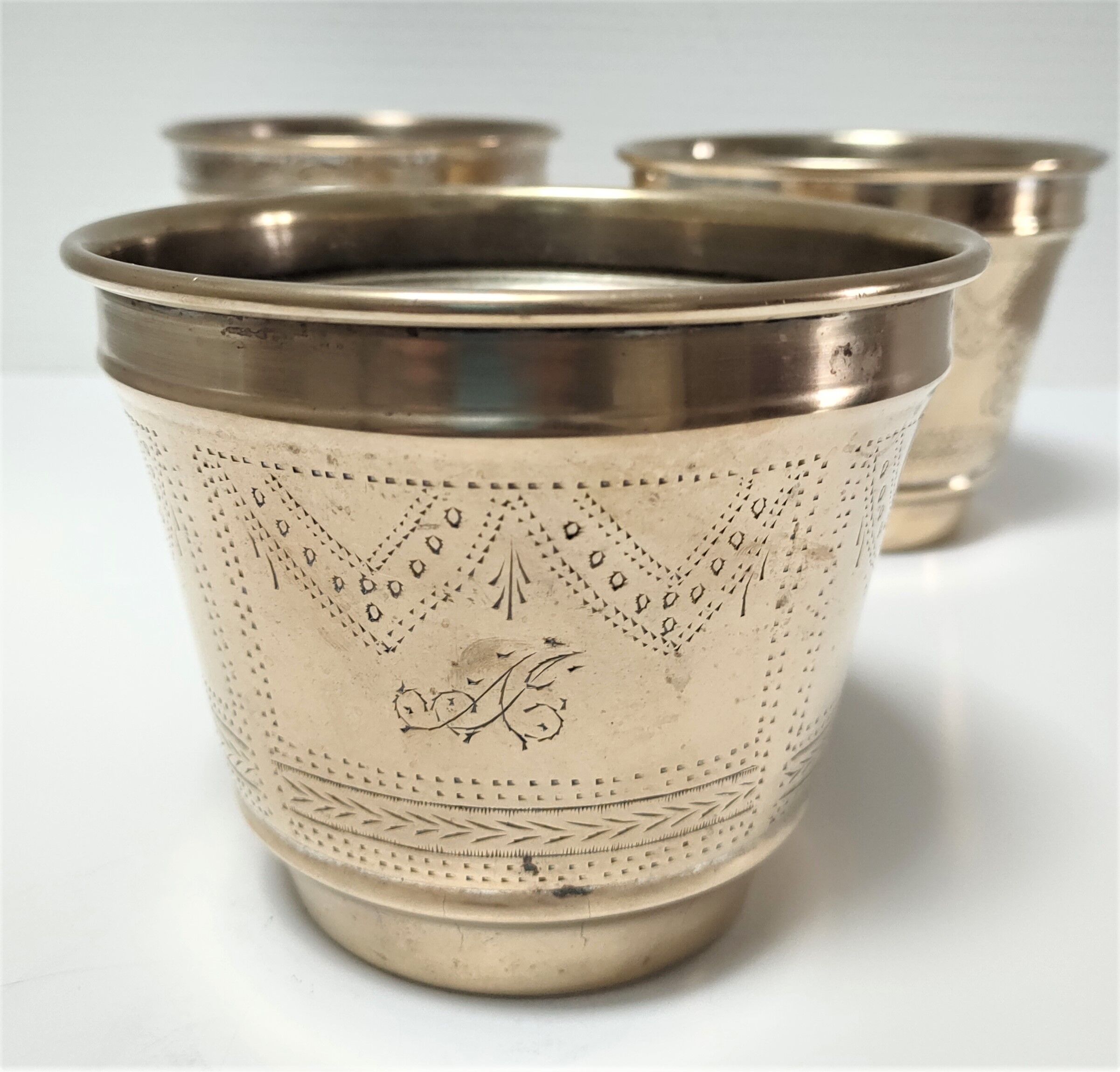Three pot covers brass silver cover golden patina monogram early twentieth century