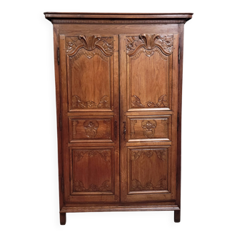 Louis XIV period wardrobe in solid oak, decorated with superb carvings