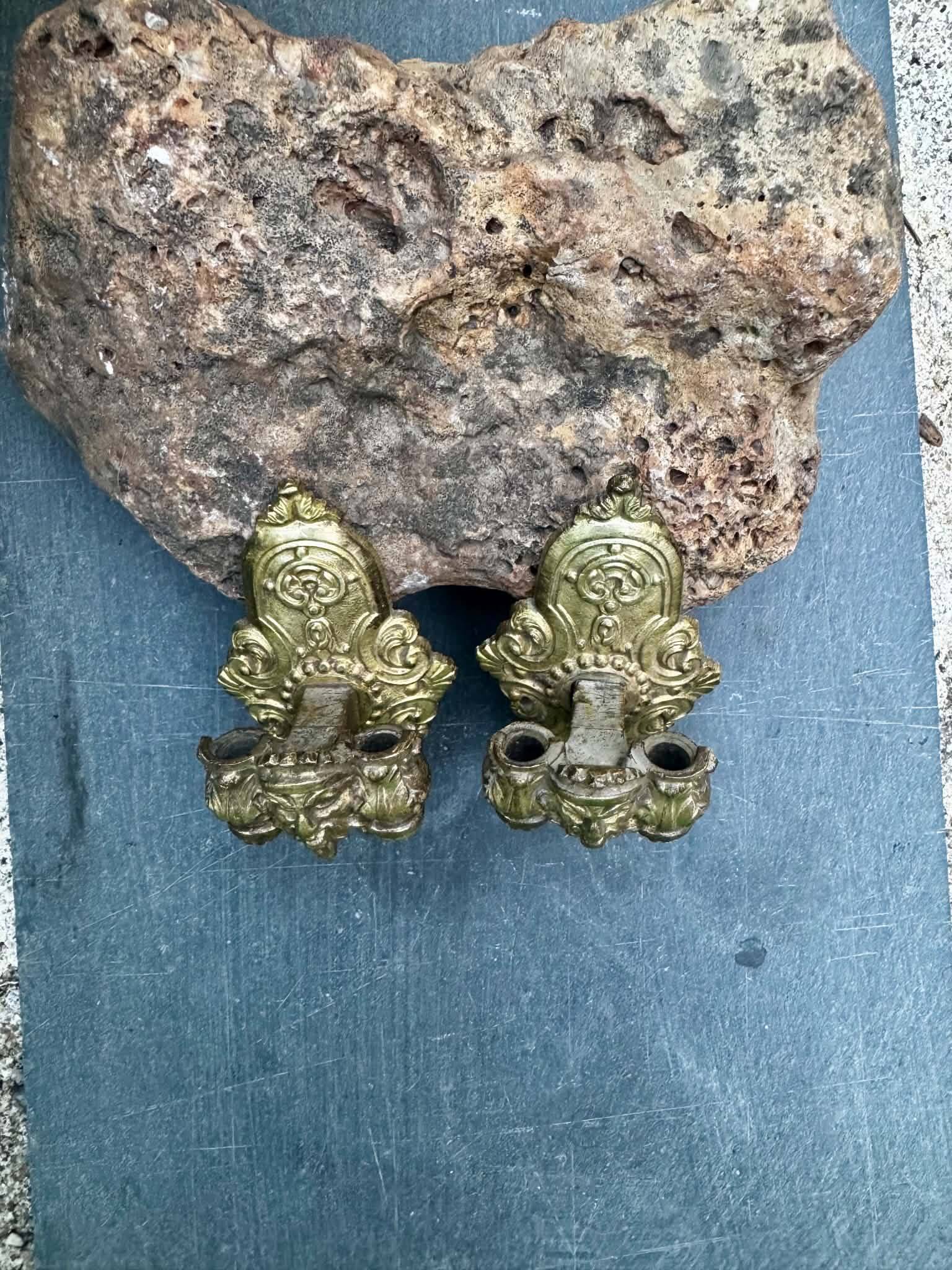 Pair of bronze wall sconces with mask, signed L. Pinet, Art Nouveau period.