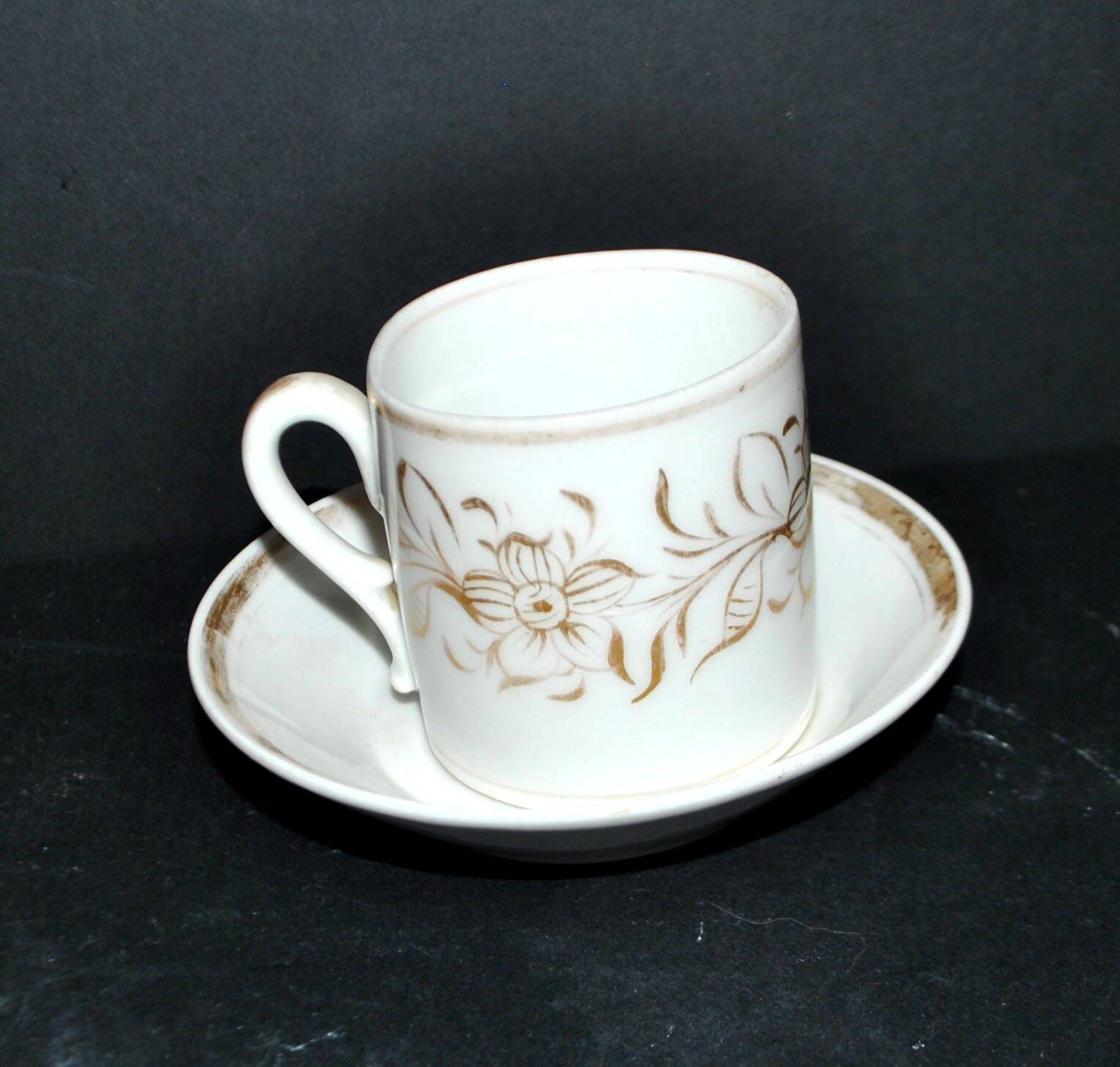 Paris porcelain coffee cup with floral design, antique porcelain with gold trim.