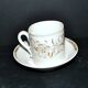 Paris porcelain coffee cup with floral design, antique porcelain with gold trim.