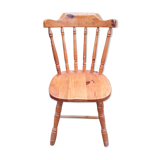 Light-coloured wooden american armchair
