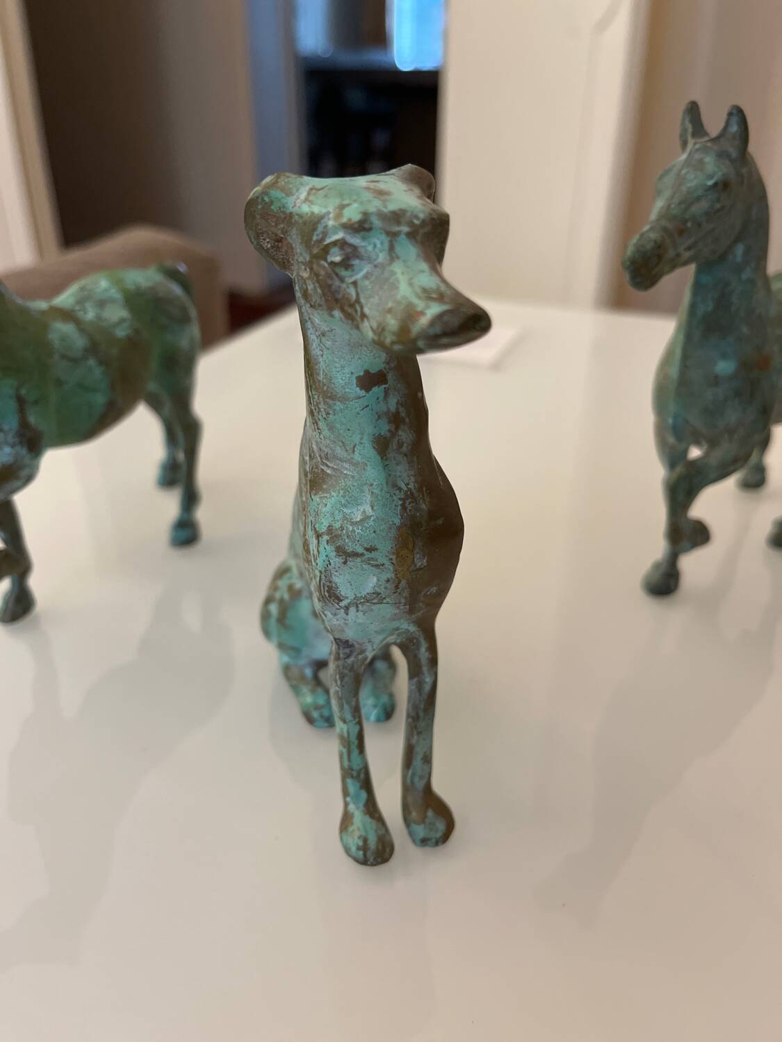 bronze statues of horses and dogs