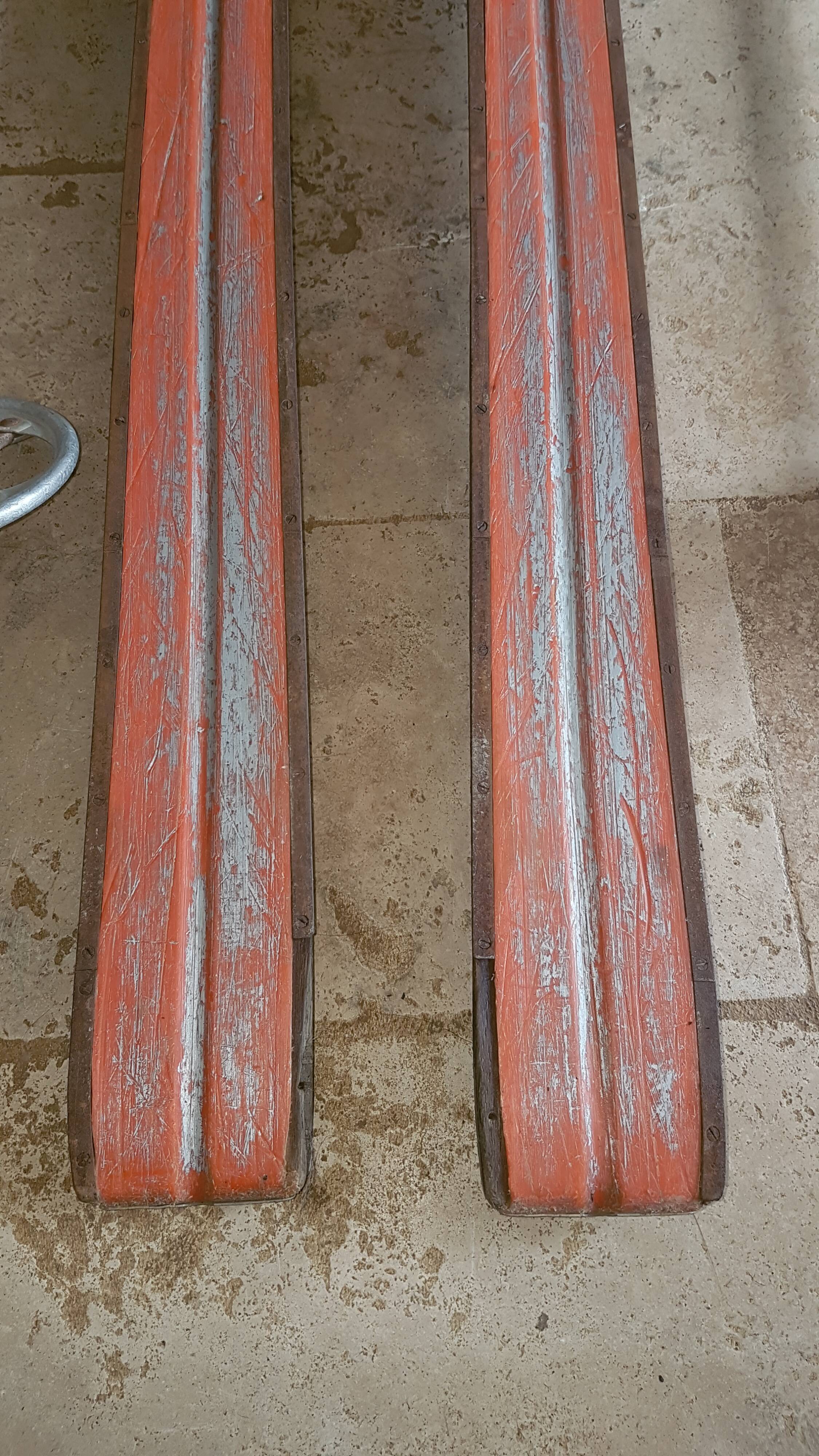 Old skis wooden and its pair of sticks