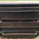 Blackened wooden chest of drawers with 5 drawers