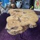 Tripod coffee table in natural solid elm magnifying glass