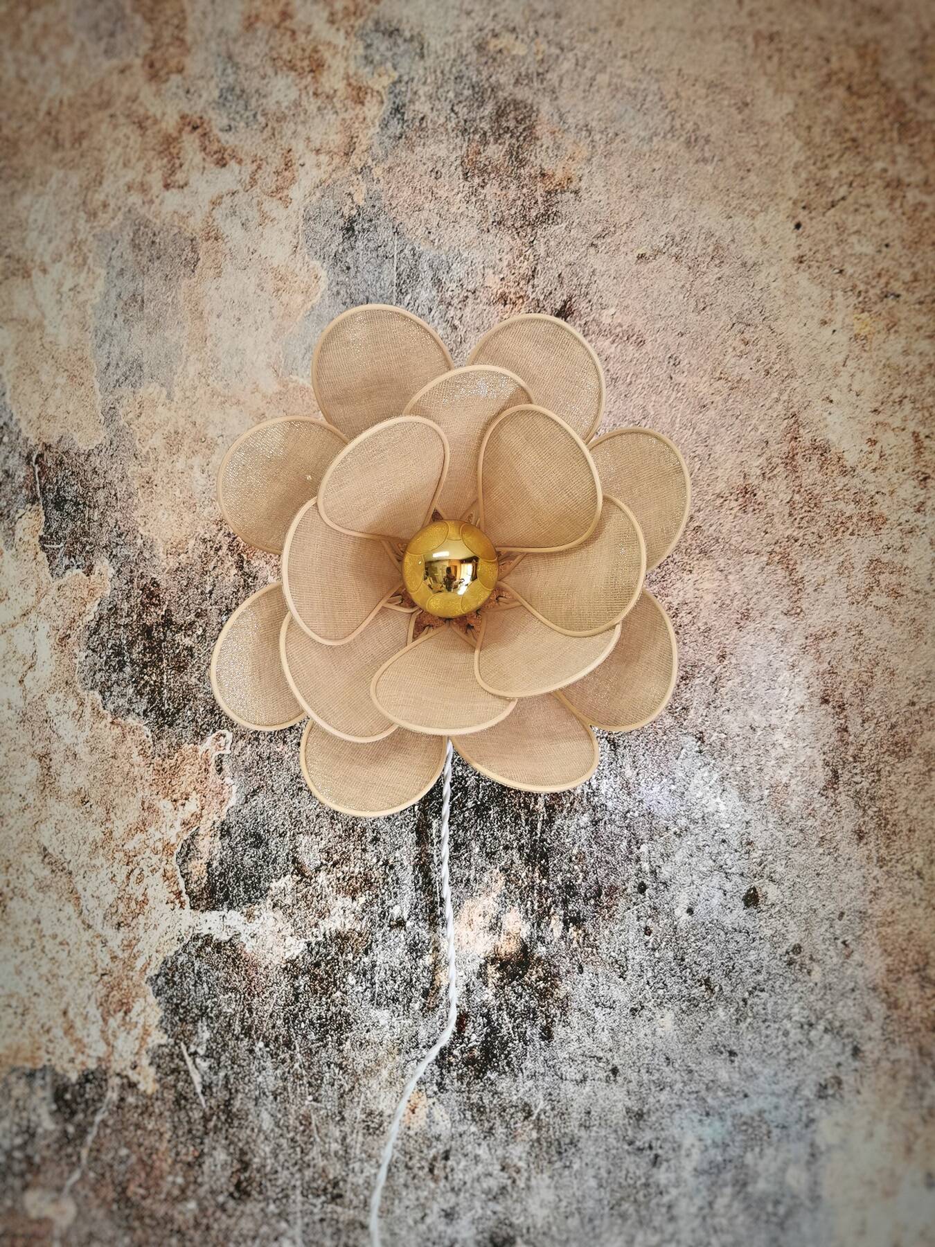 Flower wall light made of rattan petals and gold fabric