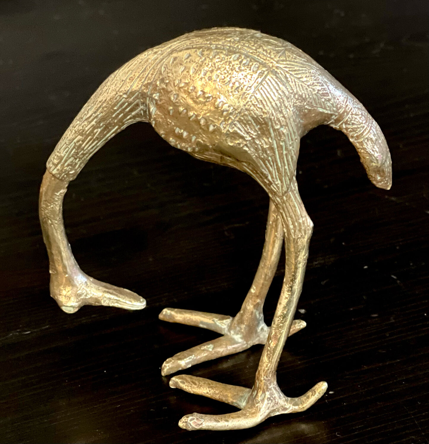 Heron in brass.