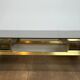 Modernist coffee table in brass and smoked glass tops by Guy Lefèvre for Maison Jansen.