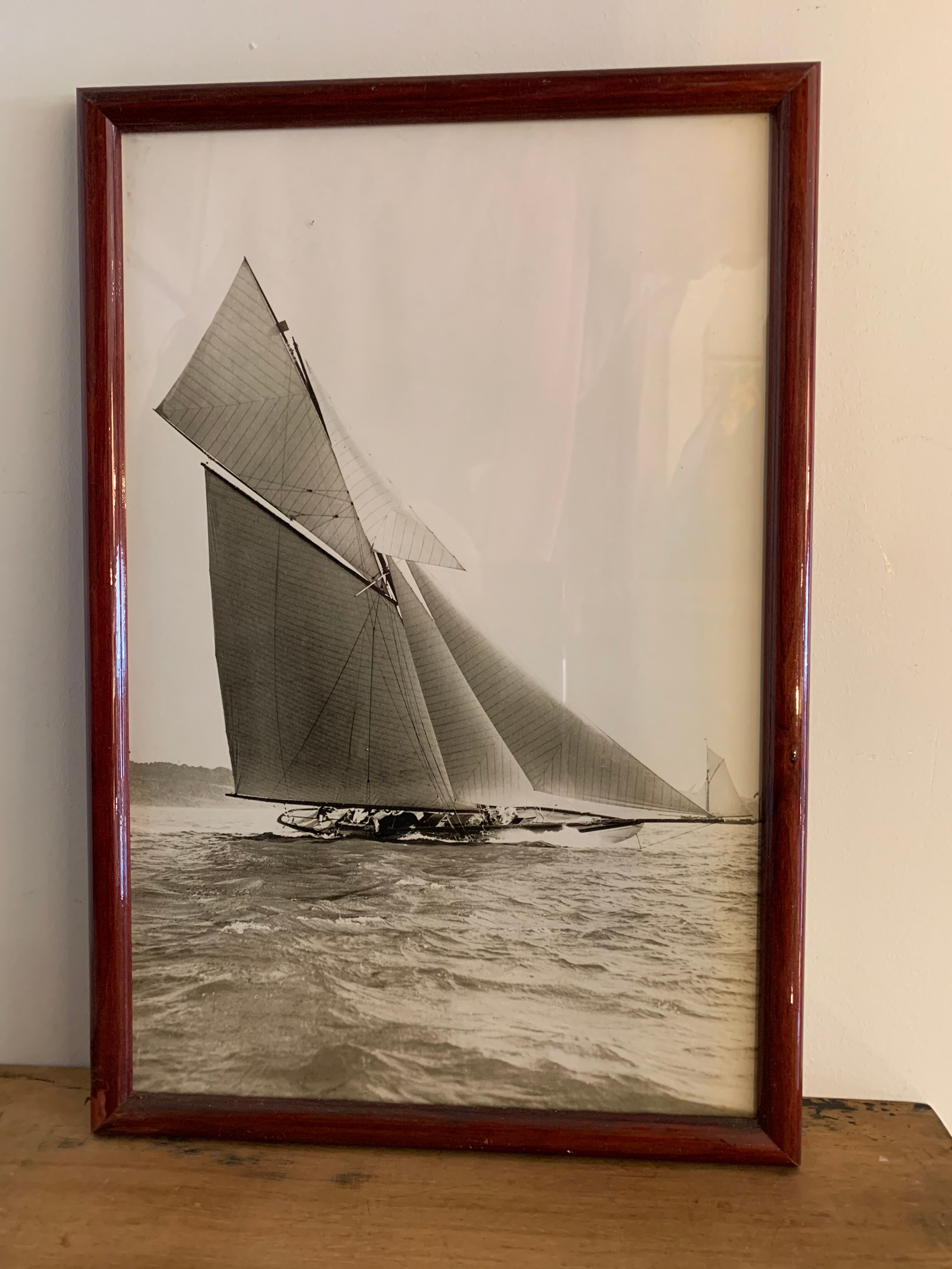 Three black and white-themed photographs sailboat boat with mahogany frame