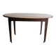 Antique wooden folding table with a patina and brass wheels.