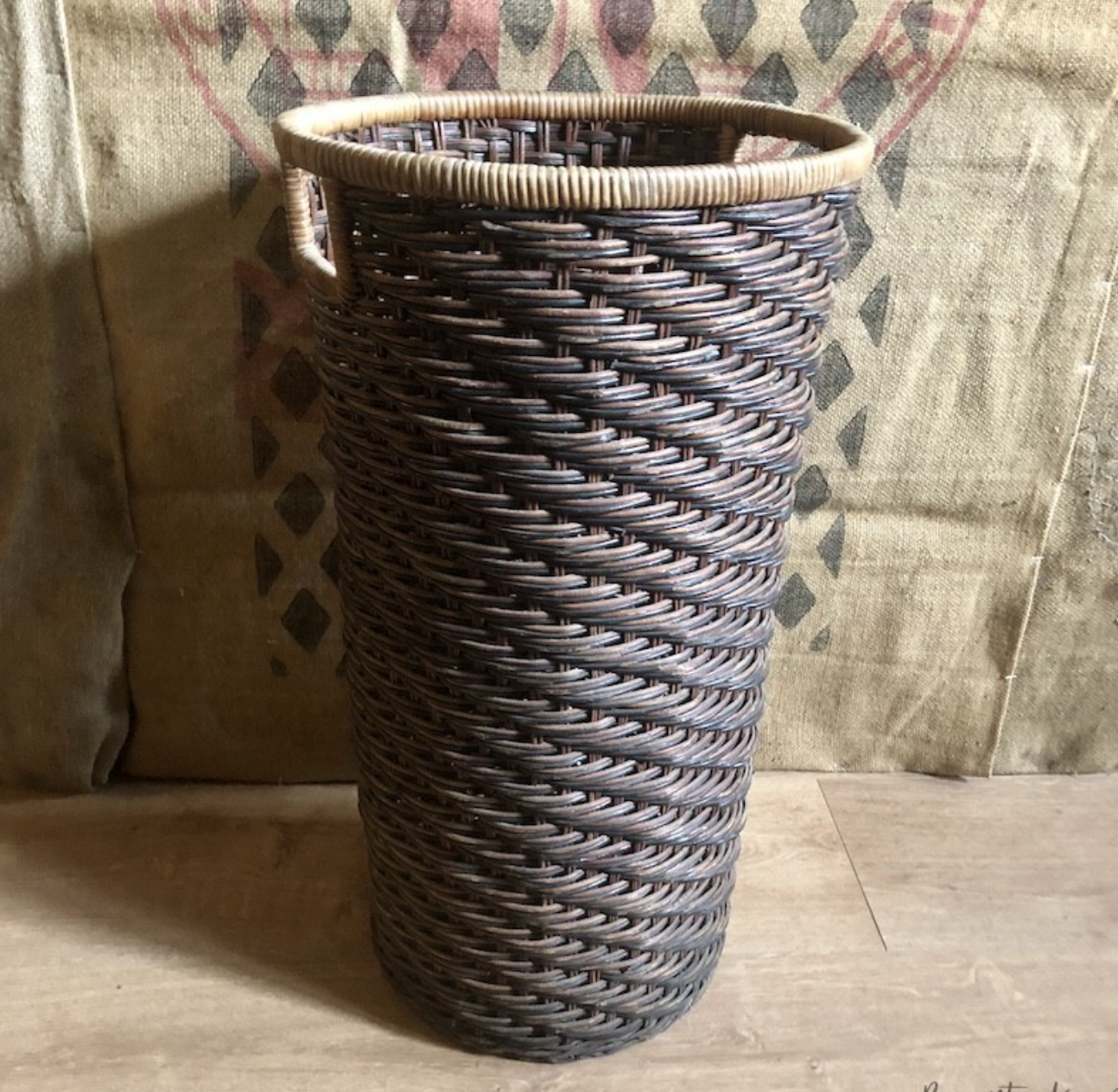 High basket in braided wicker