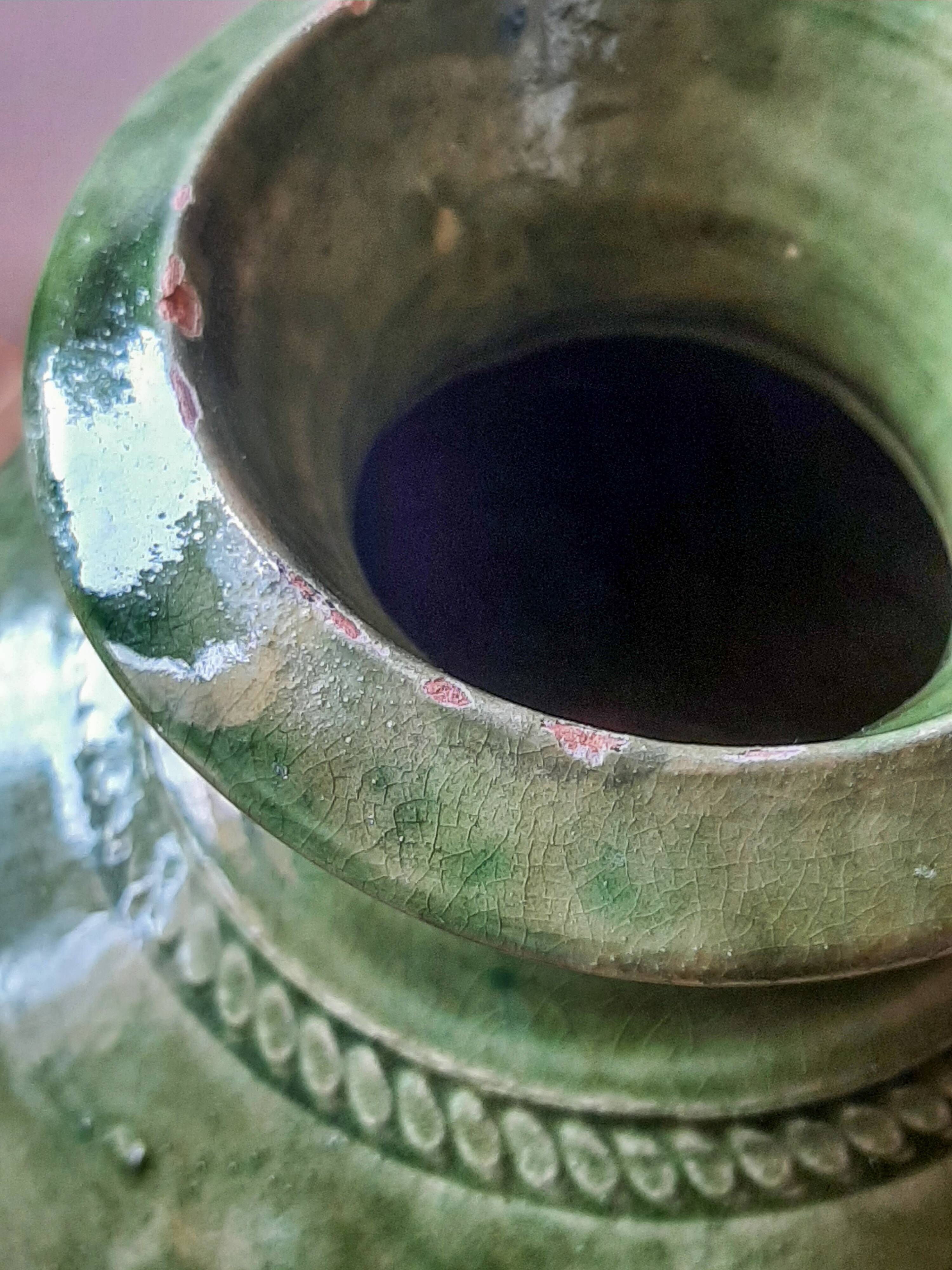 Ancient vase in glazed terracotta with green glaze.