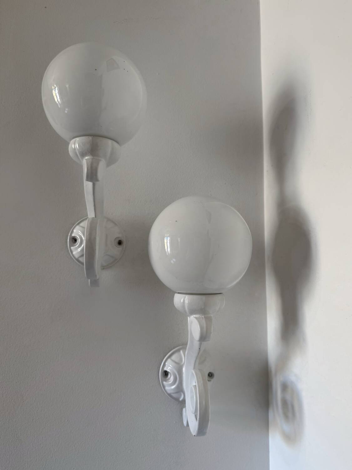 Cast iron and opaline wall lights from the 70s