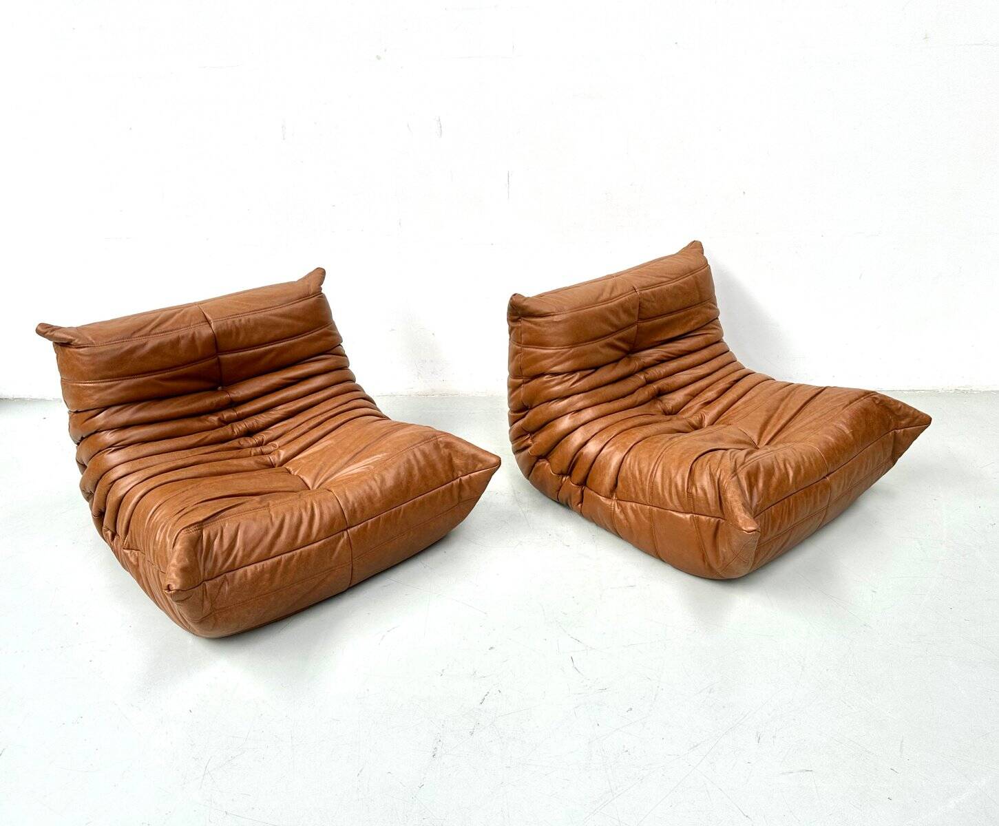 Togo lounge chairs in cognac cow leather attributed to Michel Ducaroy for Ligne Roset, set of 2