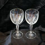 A pair of engraved crystal wine glasses