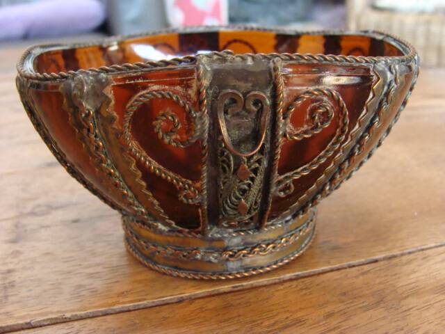 Small glass cup in metal frame