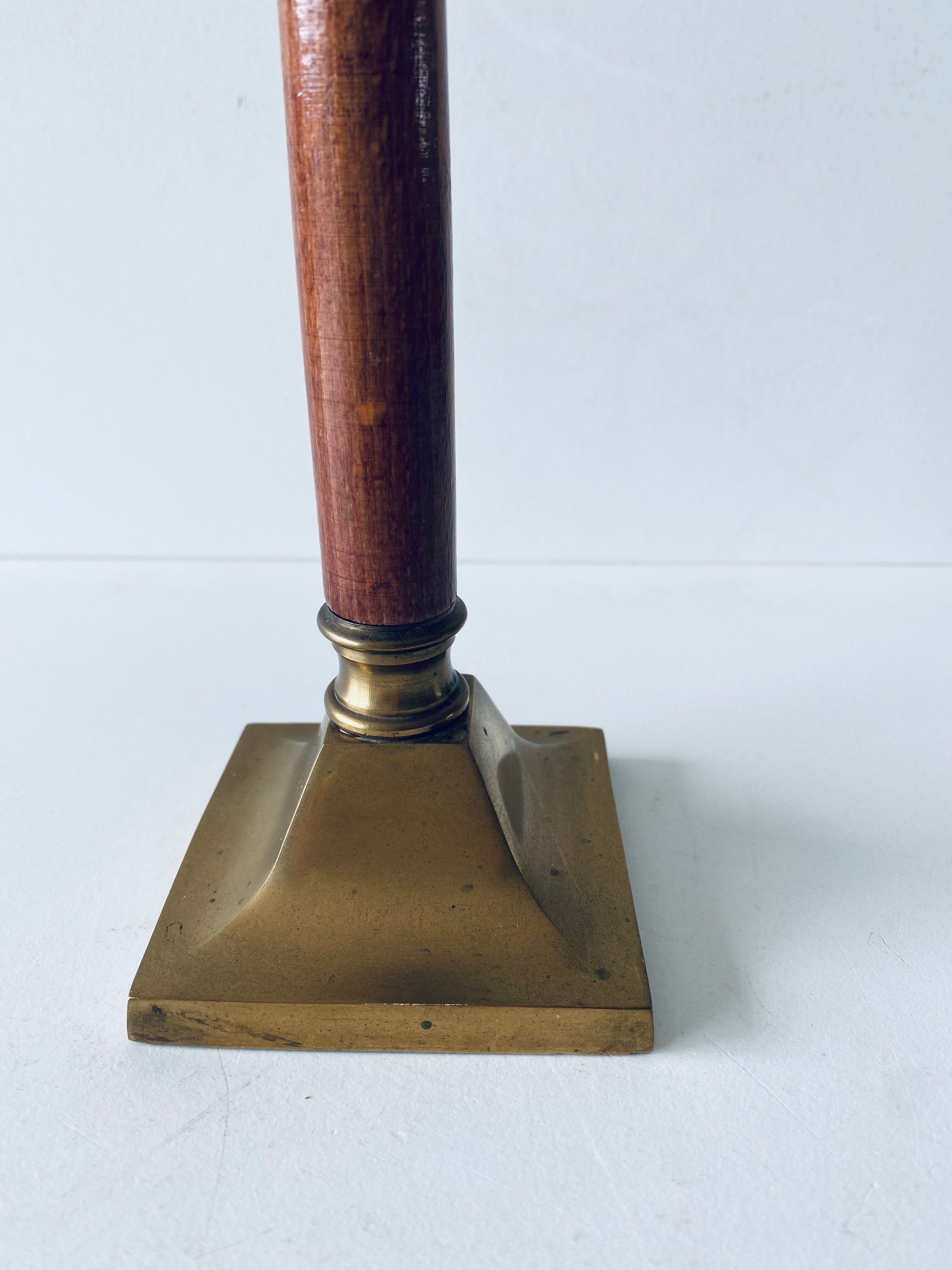 Old candle holder in brass and wood