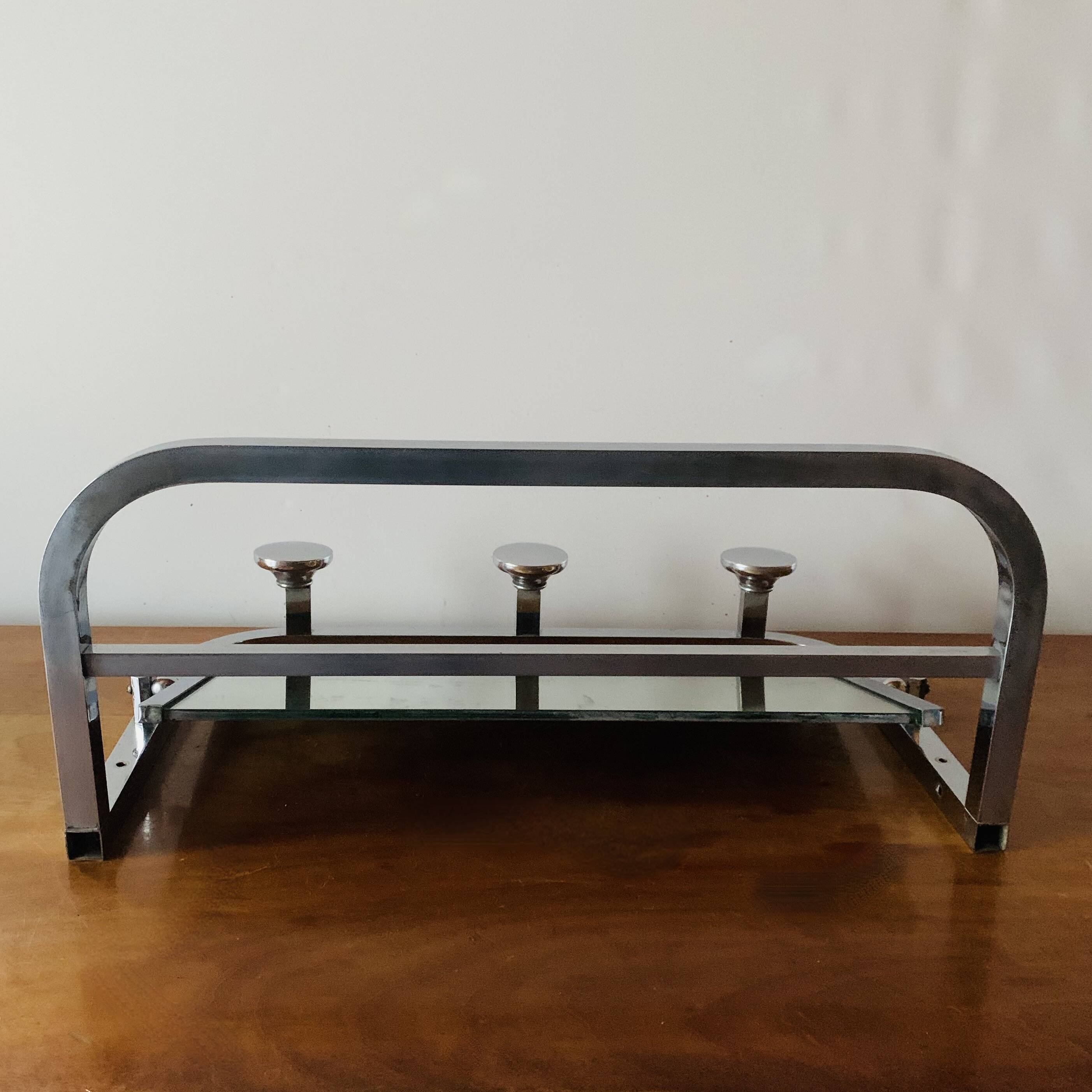 Vintage wall-mounted coat rack in chrome metal with integrated mirror and hat rack