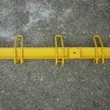 Yellow metal wall coat holder
