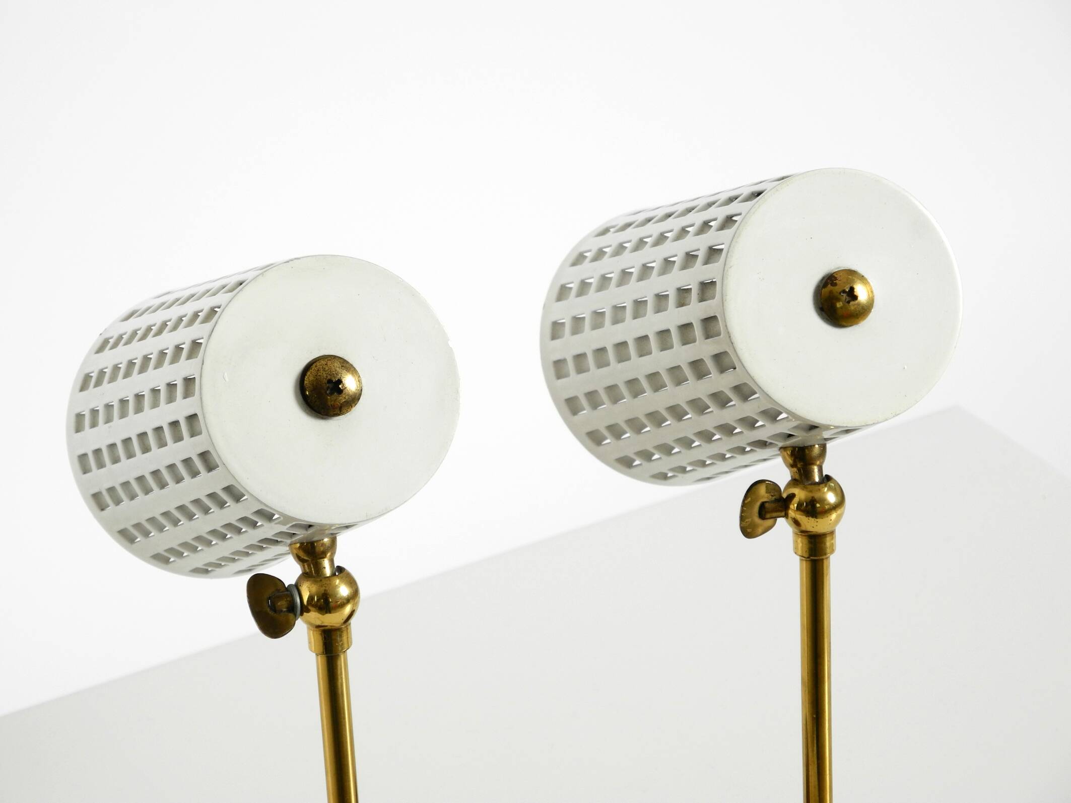A pair of mid-century modern bedside lamps with perforated metal shades