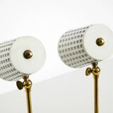 A pair of mid-century modern bedside lamps with perforated metal shades
