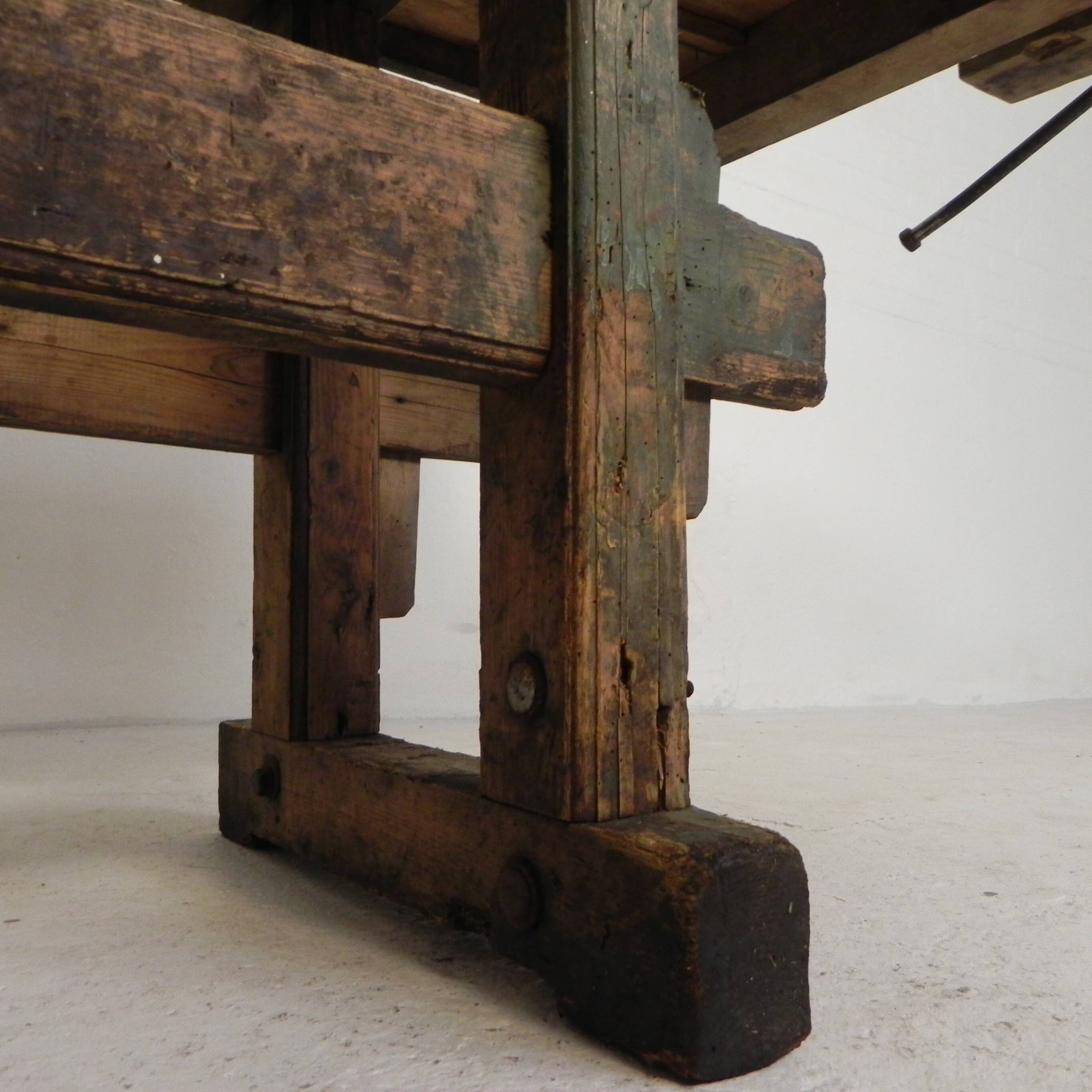 Wooden industrial workbench with vice, 194 cm long, 1930s.