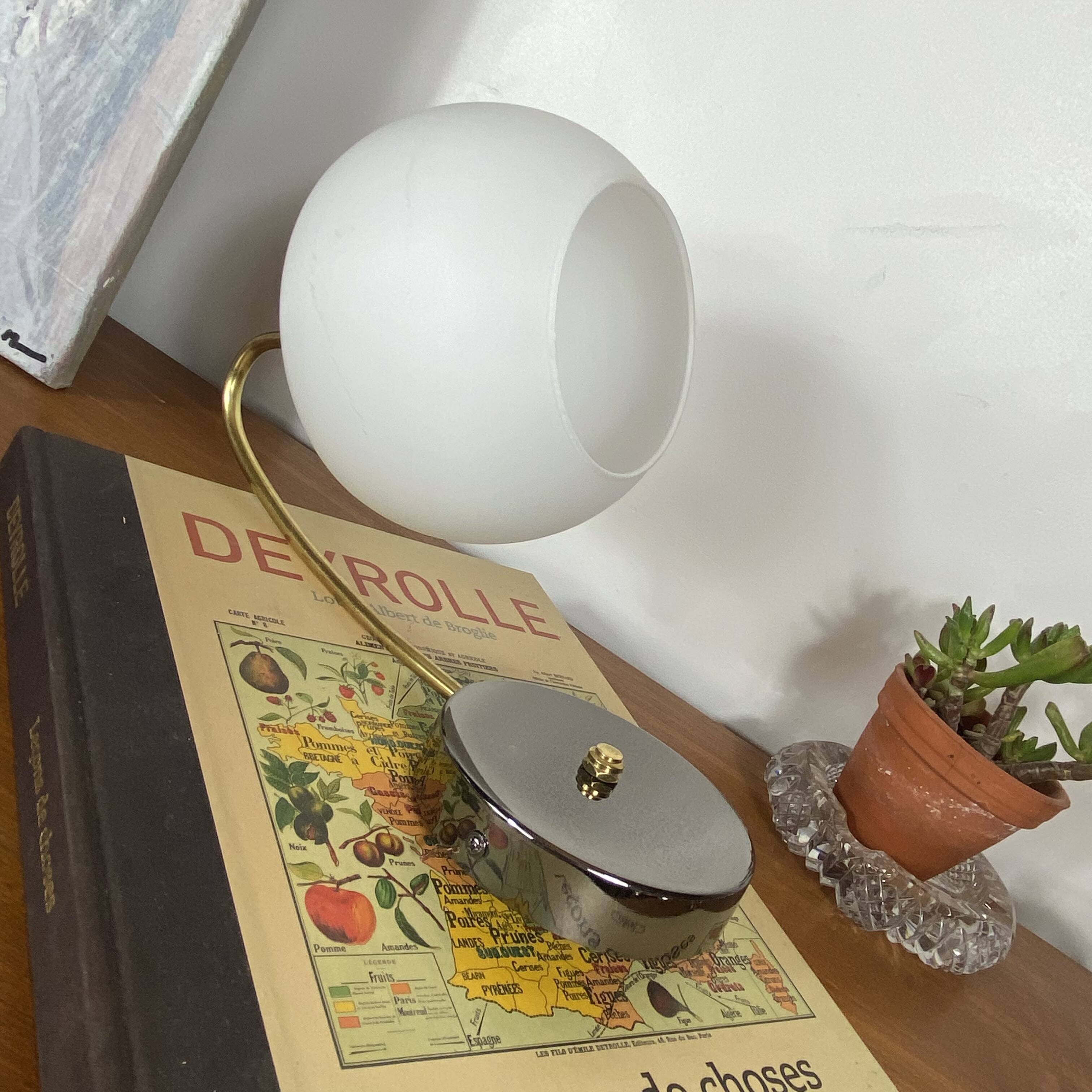 Antique swan neck wall light in brass with a white opaline tulip shade.