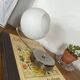 Antique swan neck wall light in brass with a white opaline tulip shade.