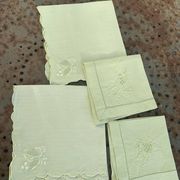 4 small tea towels, mismatched in linen, embroidered, two with flowers and two with fishermen