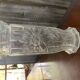 Transparent glass vase with relief floral decoration from the 1980s, fluted neck and polygonal base.