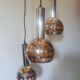Raak three-light space age orange pendant lamp, 1970s, Netherlands