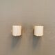 Wall lamps with milky white acrylic plastic shades and solid brass bases