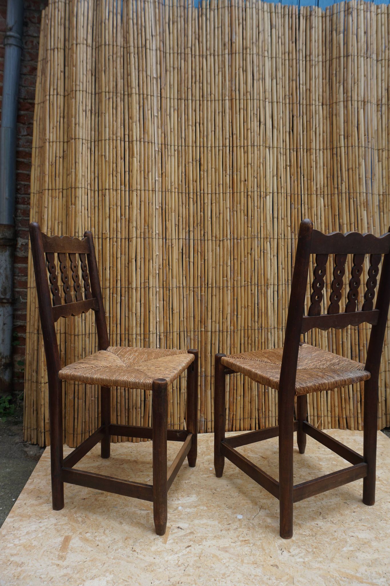 Pair of antique straw-seated farm chairs