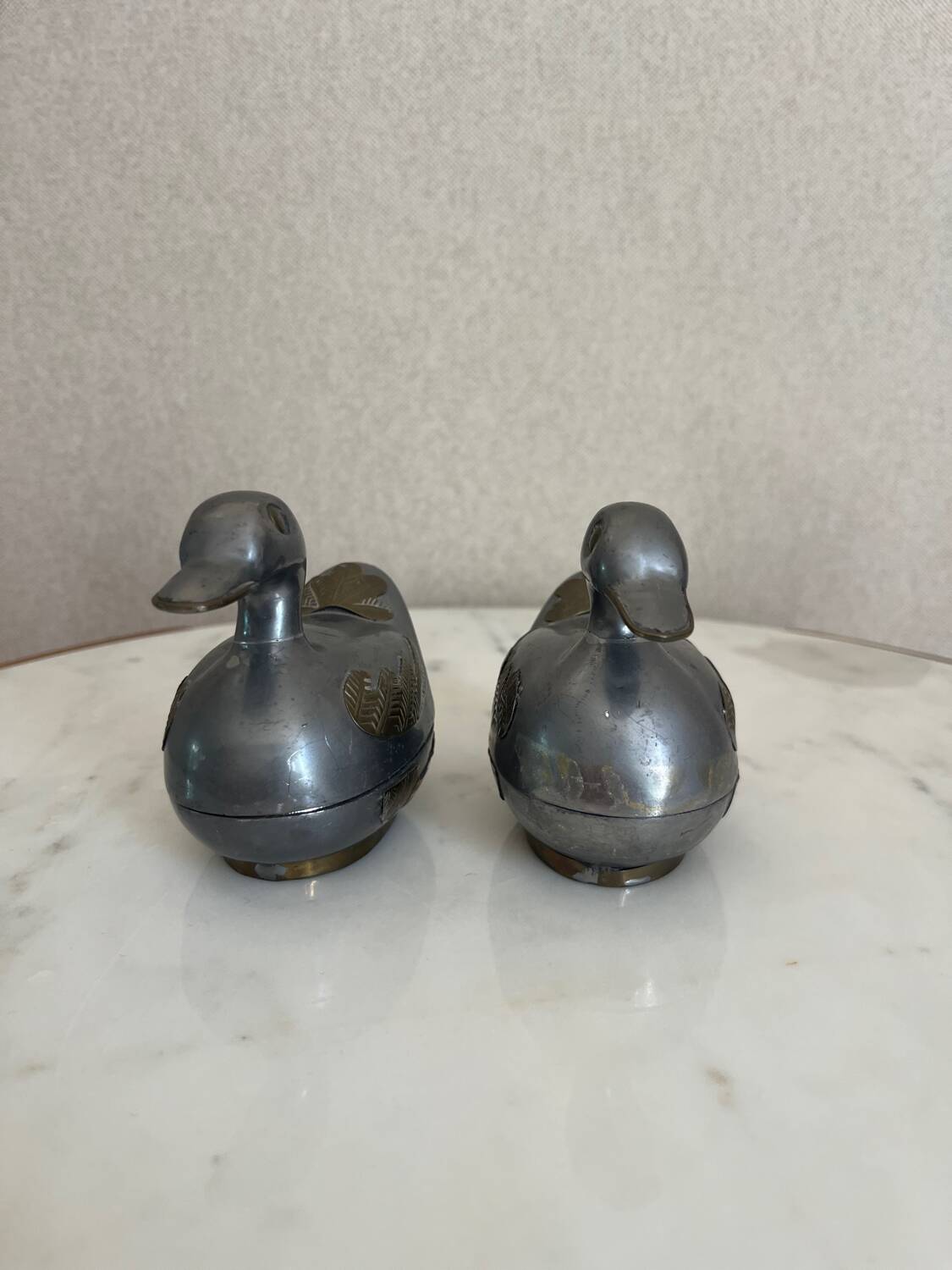 Pair of vintage decorative metal boxes in silver, shaped like ducks.