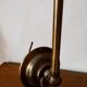 Brass wall lamp with pale pink bell