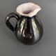 Antique black pitcher with white collar