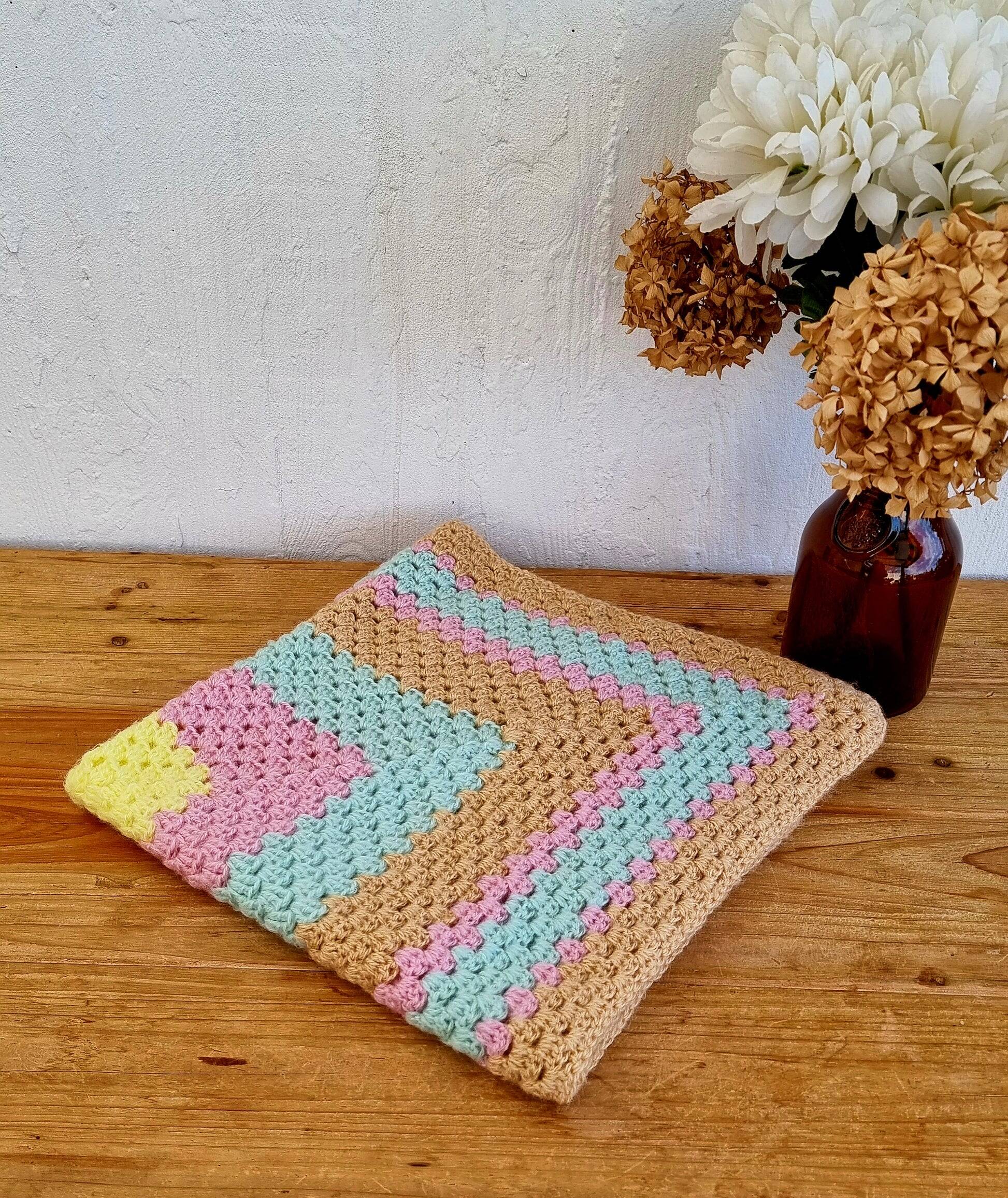 Vintage pastel crochet blanket for children.
