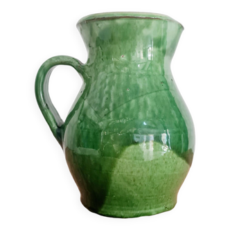Old green pitcher in painted terracotta